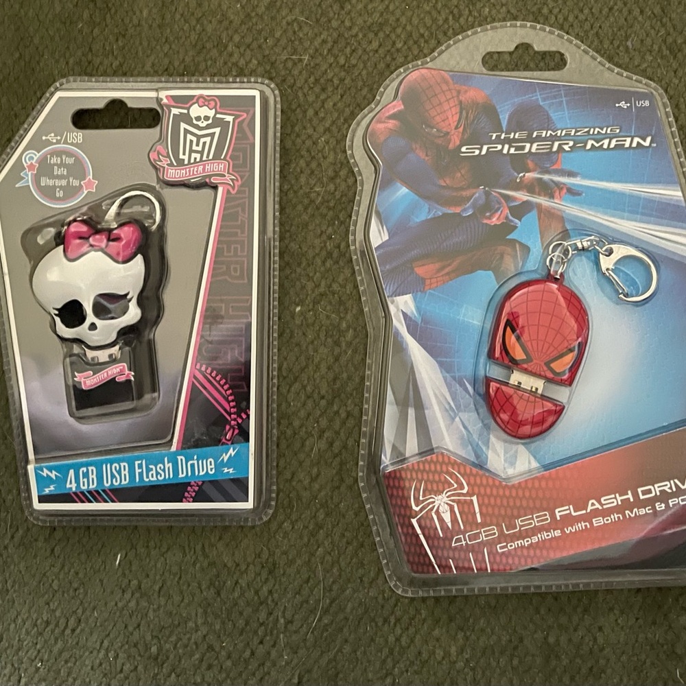 Funky 4GB USB flash drives featuring Monster High and Spider-Man designs.